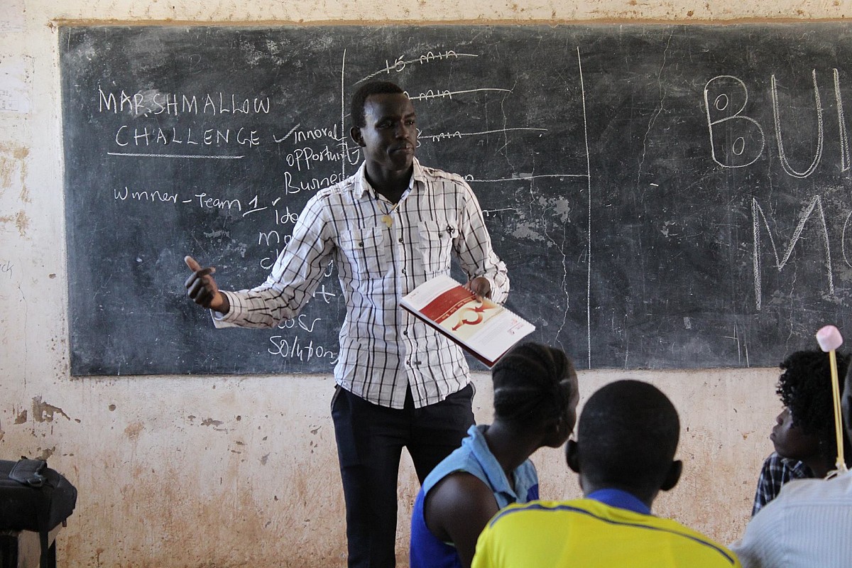 teen entrepreneur Daniel Deng in the front of a classroom in the South Sudan